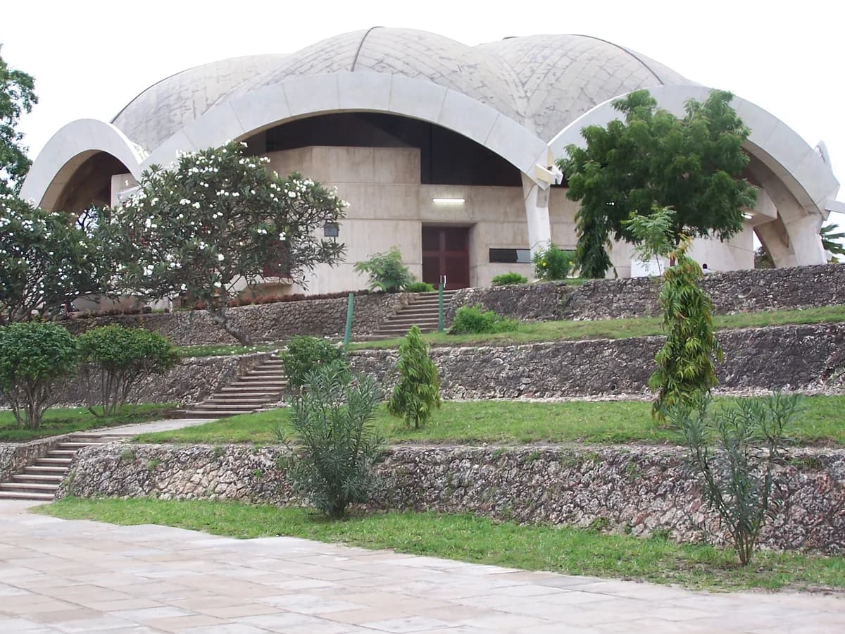 The curved concrete roof and landscaped steps of Nkrumah Hall at the University of Dar es Salaam.